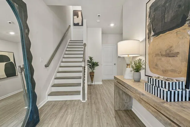 a view of entryway and hall with wooden floor