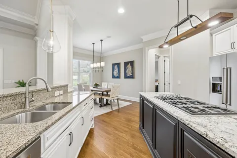 a bathroom with a granite countertop sink a toilet a mirror a bathtub and shower