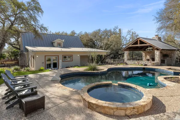 a view of a house with swimming pool and sitting area