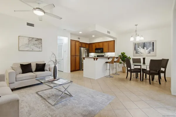 a living room with furniture and kitchen view