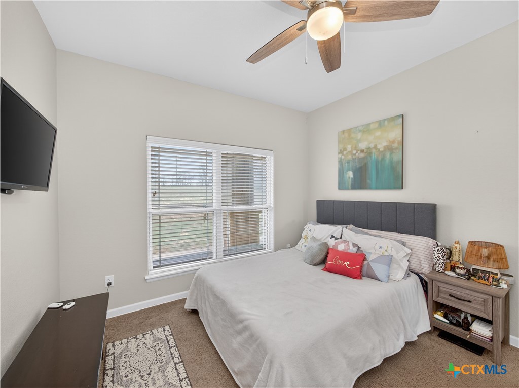 494 Flash Circle Luling, TX 78648 - Photo 19 of 44 a bedroom with a bed and wooden floor