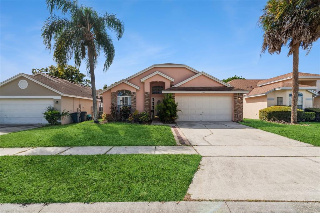 a front view of a house with a garden and plants