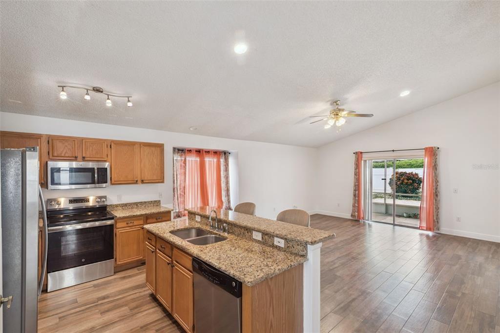 2732 Cahill Way Lake Mary, FL 32746 - Photo 3 of 20 a kitchen with stainless steel appliances granite countertop a sink stove and refrigerator
