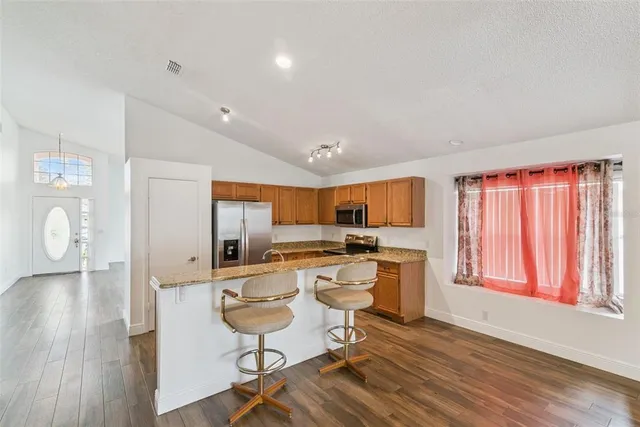 a living room with furniture a flat screen tv and a large window