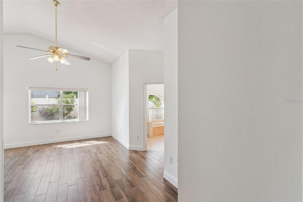 2732 Cahill Way Lake Mary, FL 32746 - Photo 9 of 20 a view of an empty room with a window and wooden floor