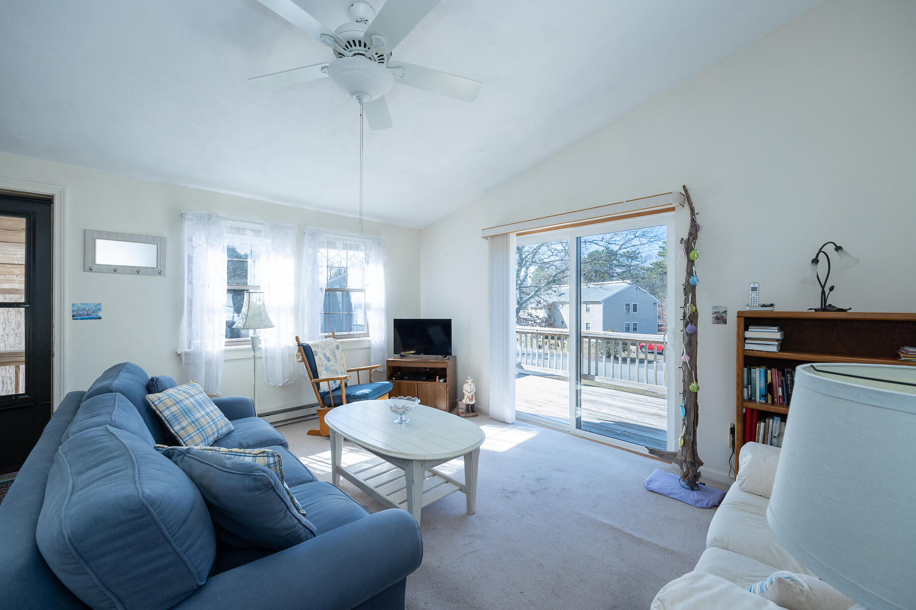 35 Ashumet Road, Unit 7D Mashpee, MA 02649 - Photo 3 of 31 a living room with furniture a flat screen tv and a large window