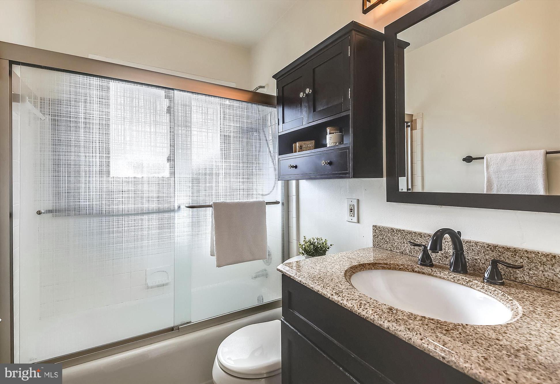 800 Malta Lane Silver Spring, MD 20901 - Photo 15 of 36 a bathroom with a granite countertop sink toilet and shower