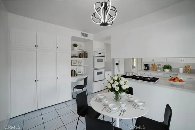 a bathroom with double vanity sinks a large mirror and a shower