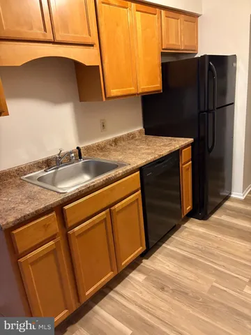 a kitchen with a sink and a refrigerator