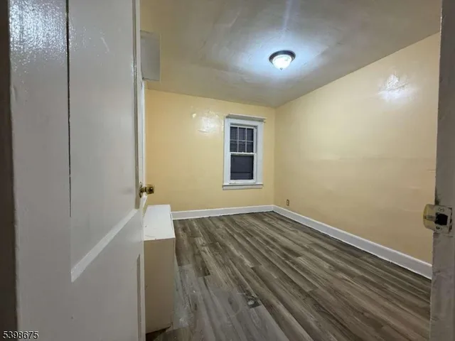 a view of hallway with wooden floor