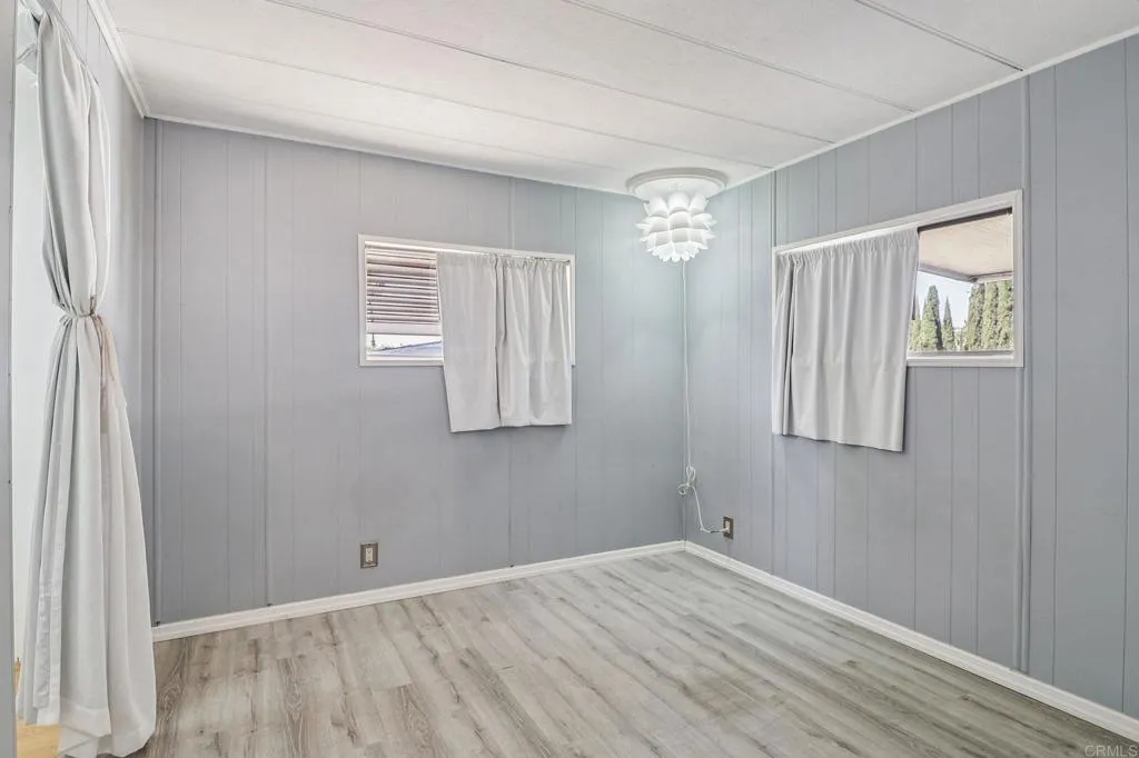 10767 Jamacha Spring Valley, Unit 217 Spring Valley, CA 91978 - Photo 12 of 24 a view of an empty room with wooden floor and a window