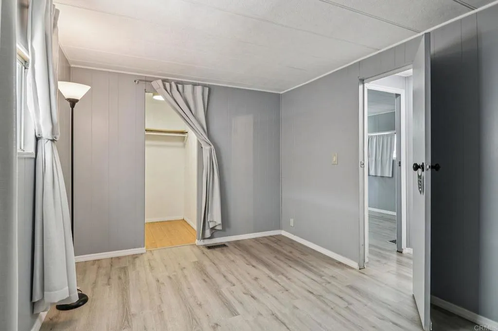 10767 Jamacha Spring Valley, Unit 217 Spring Valley, CA 91978 - Photo 15 of 24 an empty room with wooden floor and entrance