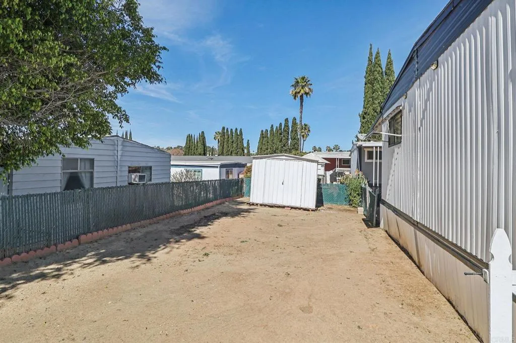 10767 Jamacha Spring Valley, Unit 217 Spring Valley, CA 91978 - Photo 24 of 24 a view of a small space in front of a house with wooden fence