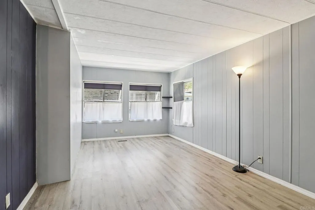 10767 Jamacha Spring Valley, Unit 217 Spring Valley, CA 91978 - Photo 4 of 24 a view of an empty room with wooden floor and a window