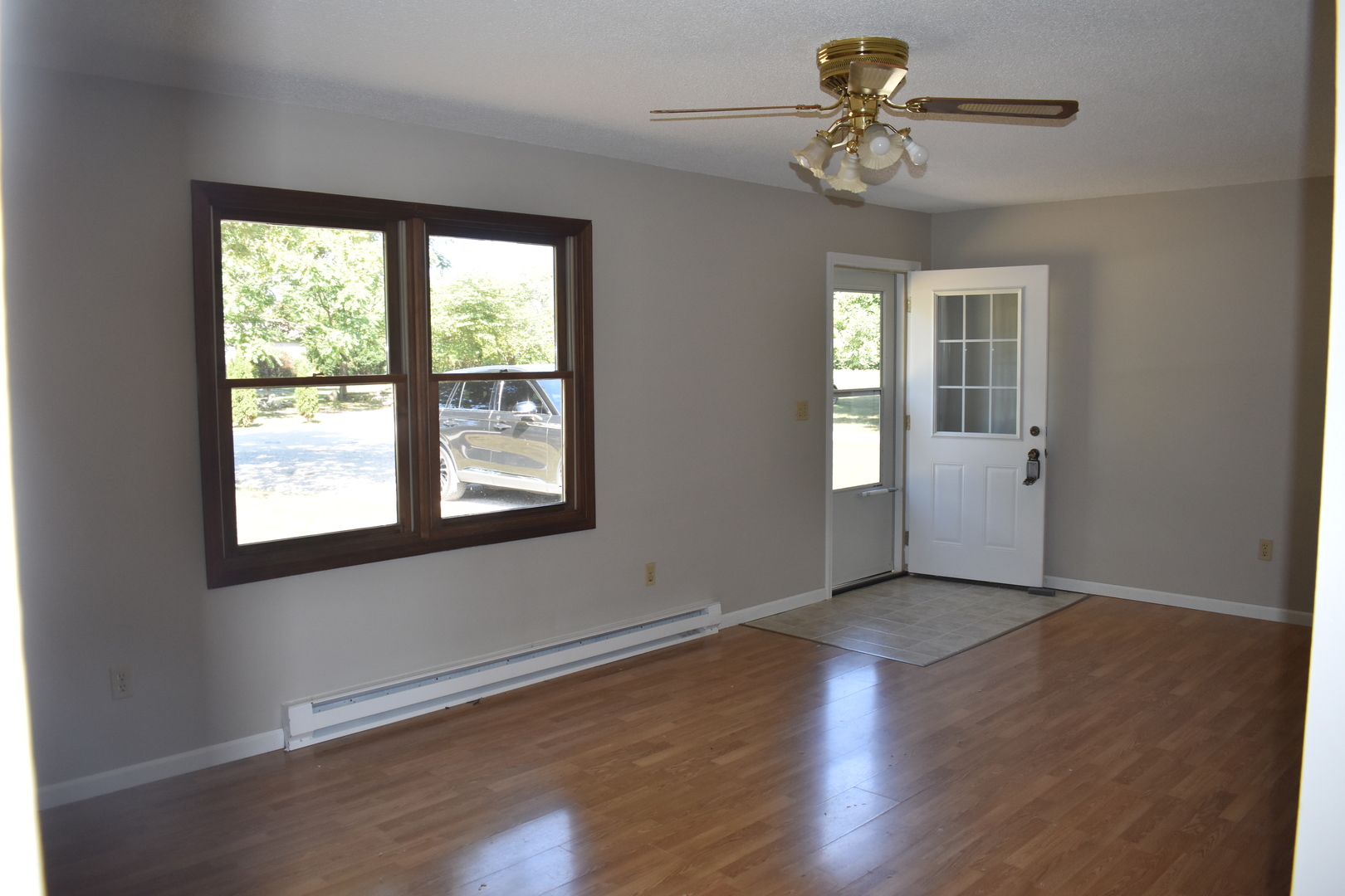 320 North Walnut Street Arcola, IL 61910 - Photo 4 of 14 a view of an empty room with a window and wooden floor