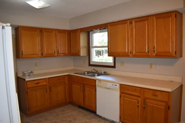 a kitchen with a sink cabinets and window