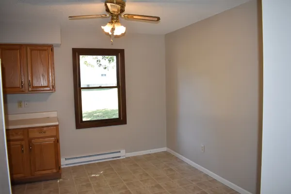 an empty room with windows and closet