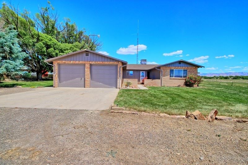 1690 M Road Fruita, CO 81521 - Photo 1 of 1 a front view of a house with a yard and garage