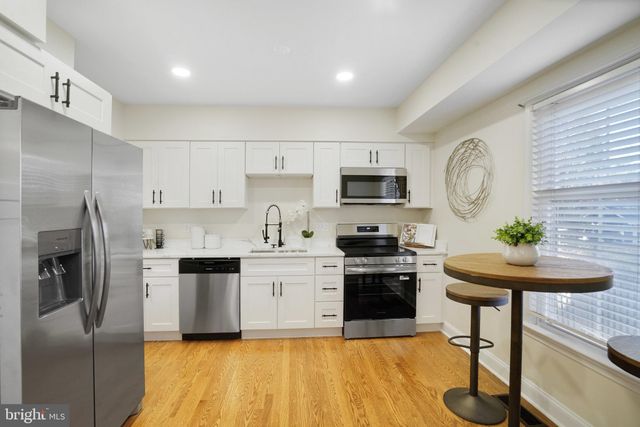 a kitchen with a sink stainless steel appliances and cabinets