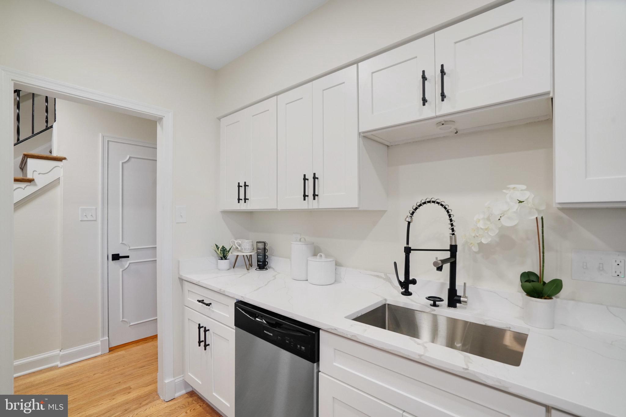 3135 14th Street South Arlington, VA 22204 - Photo 14 of 53 a kitchen with white cabinets a sink and dishwasher