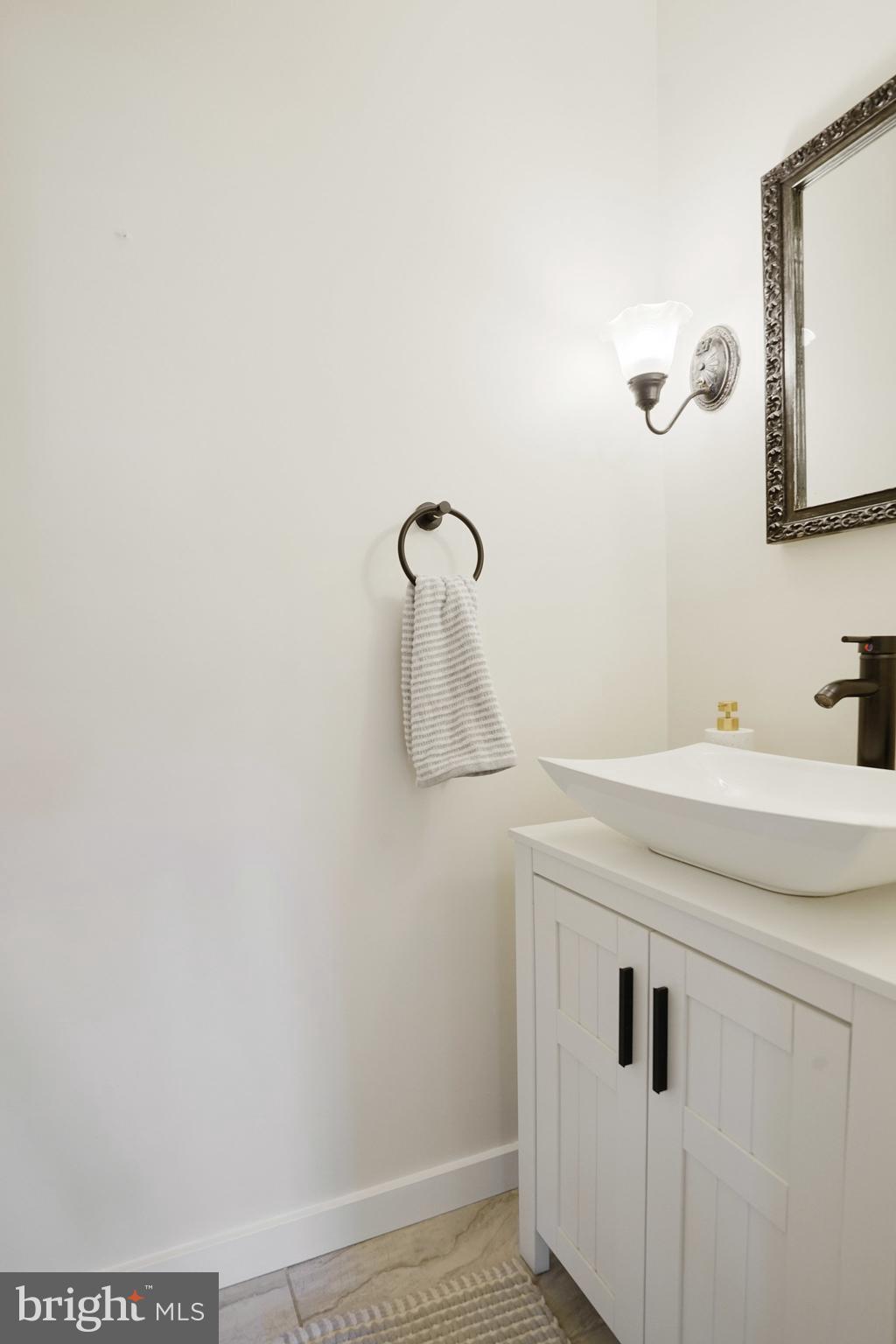 3135 14th Street South Arlington, VA 22204 - Photo 21 of 53 a bathroom with a sink and mirror