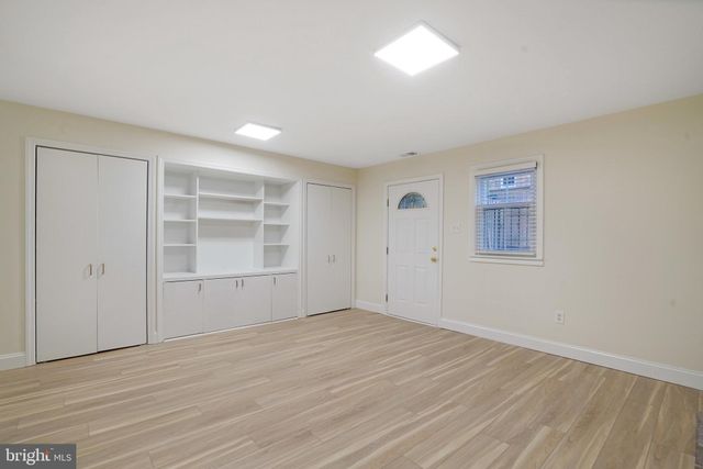 an empty room with a empty space and windows