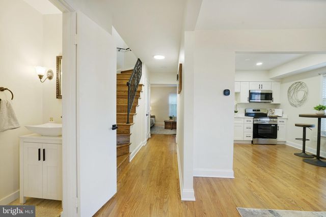 a view of a kitchen view with wooden floor and electronic appliances