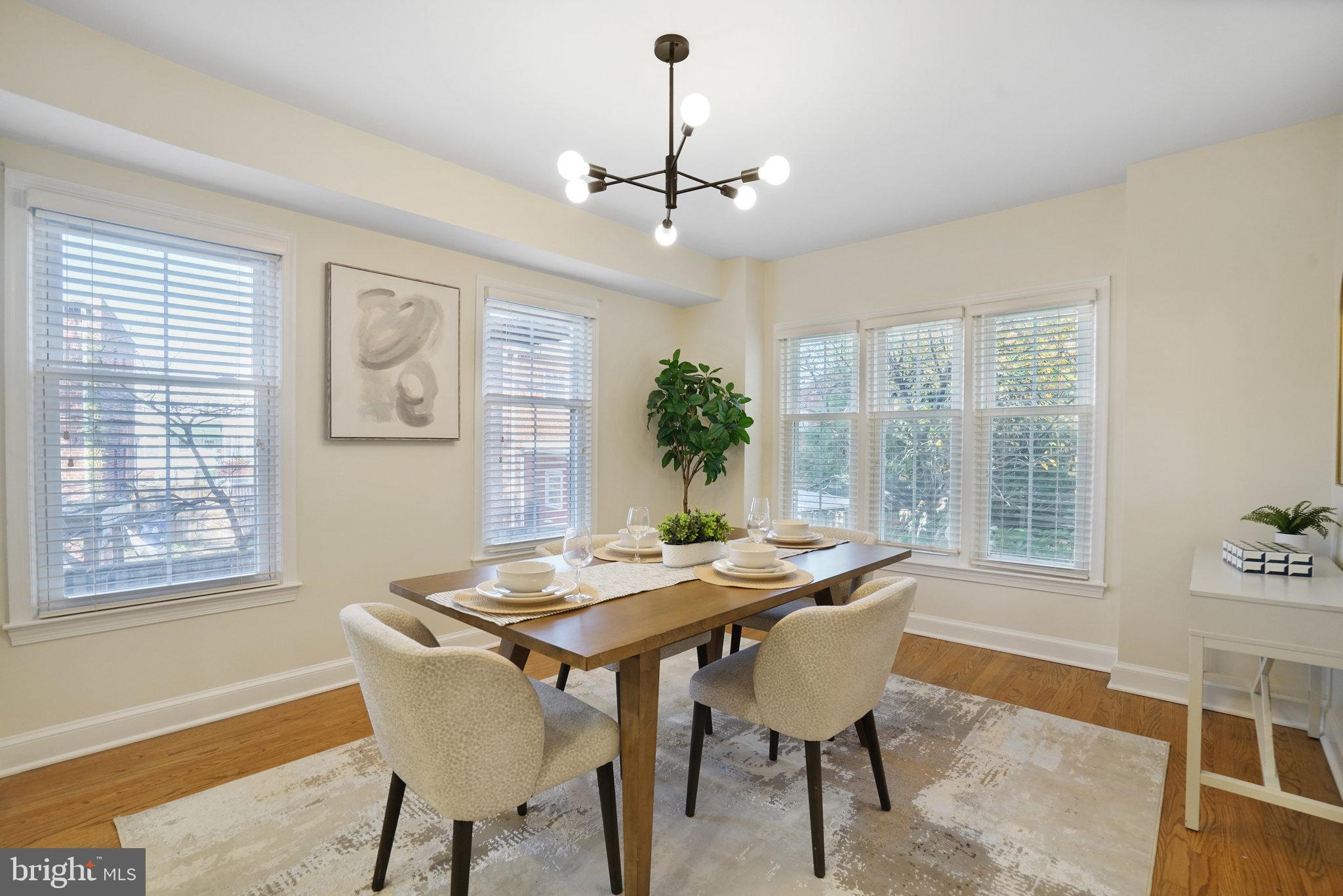 3135 14th Street South Arlington, VA 22204 - Photo 8 of 53 a dining room with furniture a chandelier and wooden floor