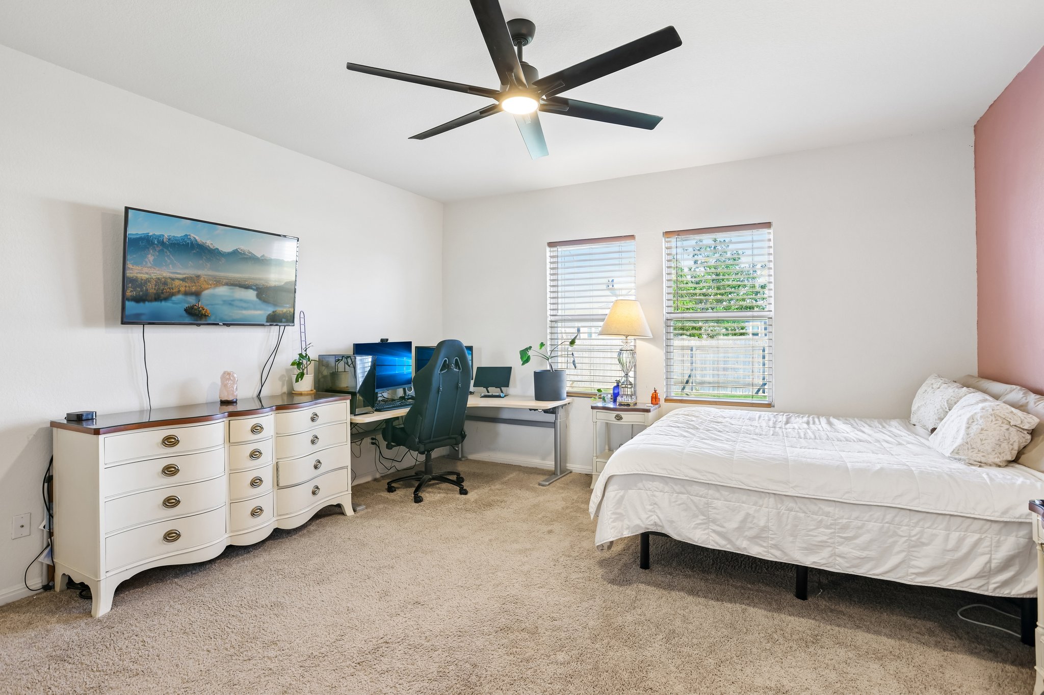 19105 Mike Mansfield Road Manor, TX 78653 - Photo 13 of 28 a bedroom with a bed and a flat tv screen on the dresser