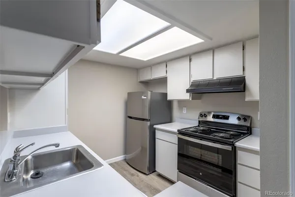 a kitchen with a stove and a sink