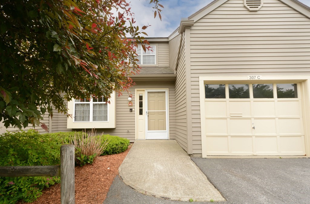 307 Ridgefield Circle, Unit C Clinton, MA 01510 - Photo 1 of 18 a front view of a house with a yard and garage