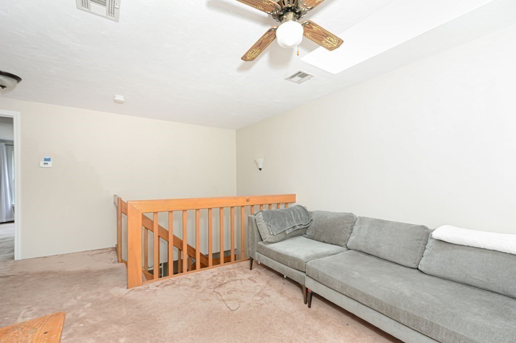 307 Ridgefield Circle, Unit C Clinton, MA 01510 - Photo 11 of 18 a living room with furniture and a chandelier