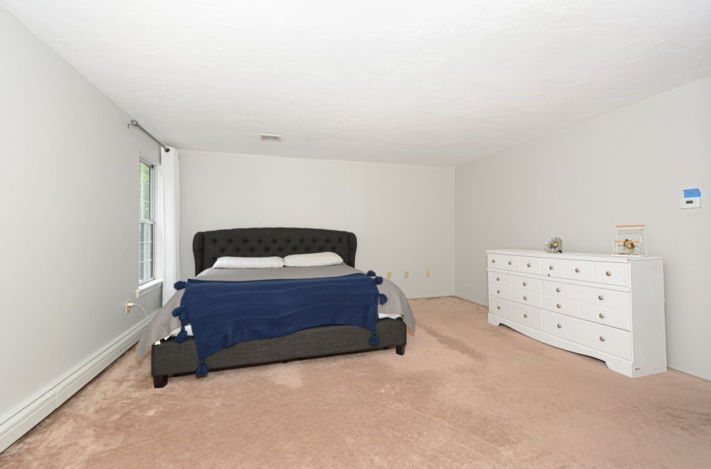 307 Ridgefield Circle, Unit C Clinton, MA 01510 - Photo 12 of 18 a spacious bedroom with a bed and a dresser