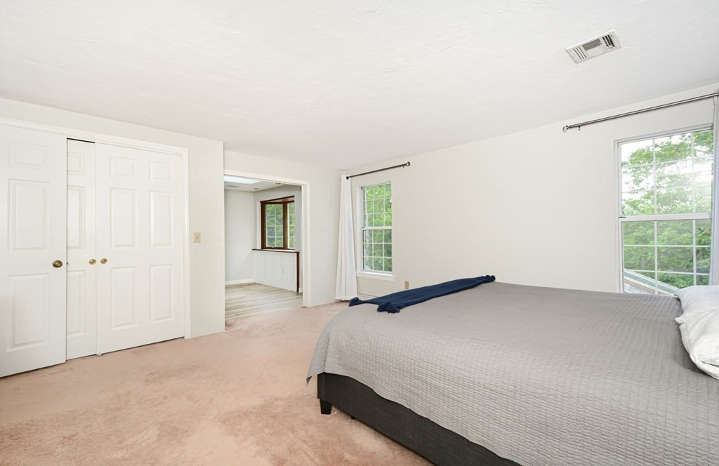 307 Ridgefield Circle, Unit C Clinton, MA 01510 - Photo 13 of 18 a bedroom with a bed and a window