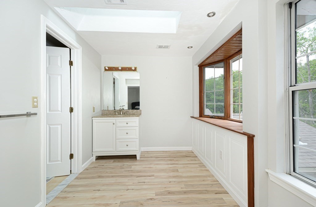 307 Ridgefield Circle, Unit C Clinton, MA 01510 - Photo 14 of 18 a view of a hallway with bathroom and wooden floor