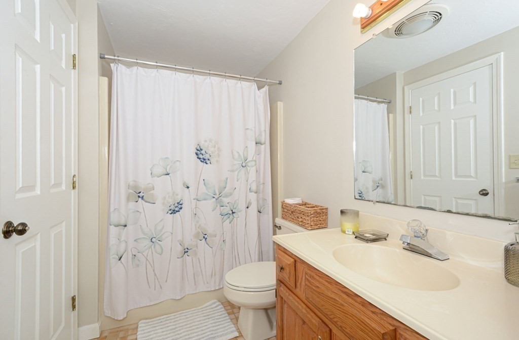307 Ridgefield Circle, Unit C Clinton, MA 01510 - Photo 15 of 18 a bathroom with a sink a toilet and shower curtain