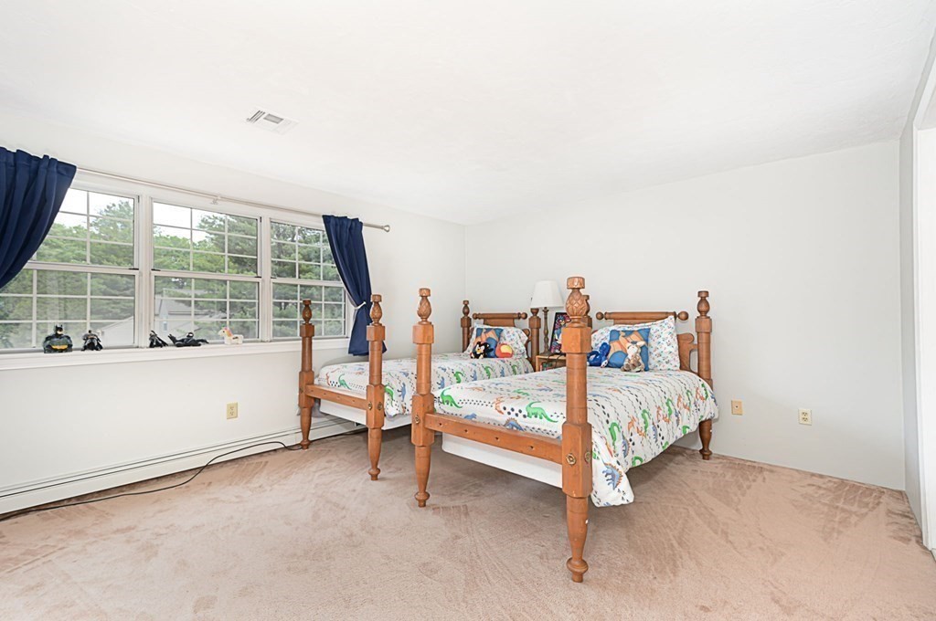 307 Ridgefield Circle, Unit C Clinton, MA 01510 - Photo 16 of 18 a bed room with a bed and a large window