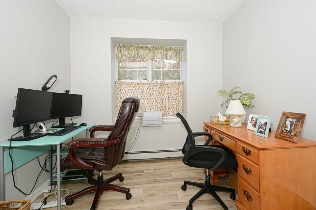307 Ridgefield Circle, Unit C Clinton, MA 01510 - Photo 2 of 18 a view of a workspace with furniture and a window