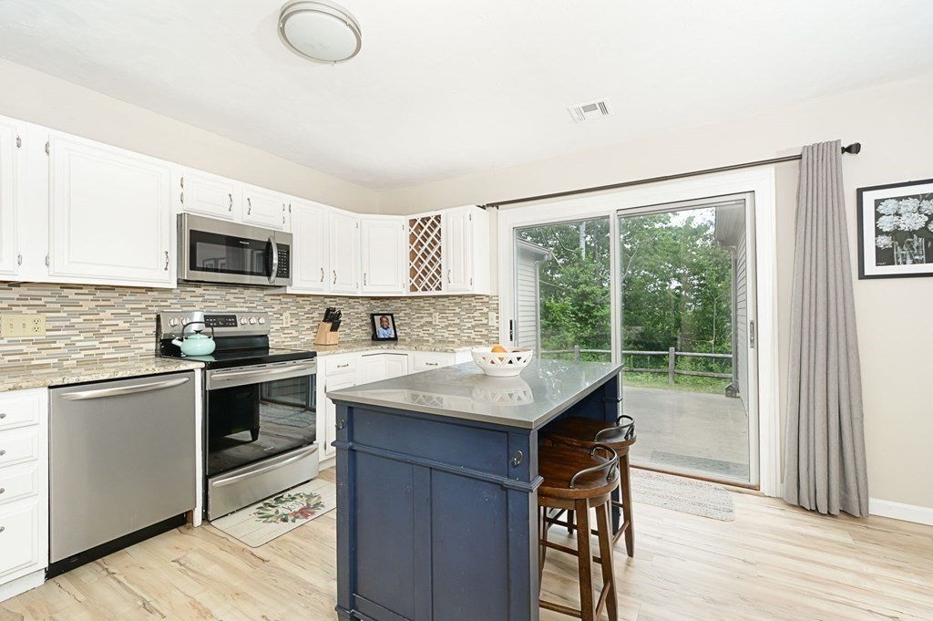 307 Ridgefield Circle, Unit C Clinton, MA 01510 - Photo 6 of 18 a kitchen with a stove a sink and a microwave