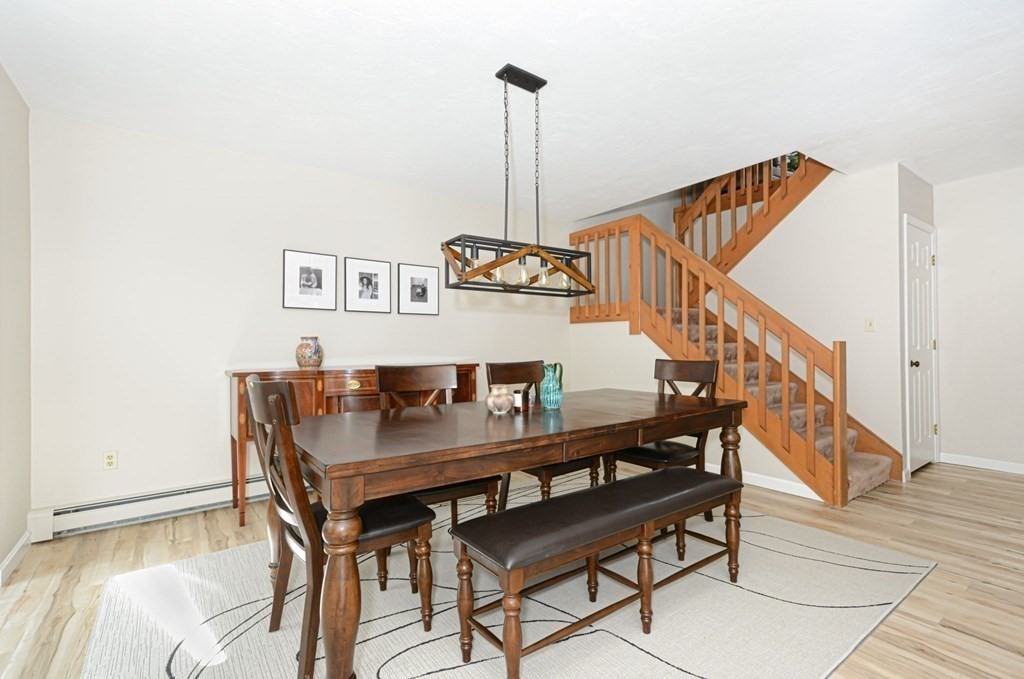 307 Ridgefield Circle, Unit C Clinton, MA 01510 - Photo 7 of 18 a view of a dining room with furniture and wooden floor