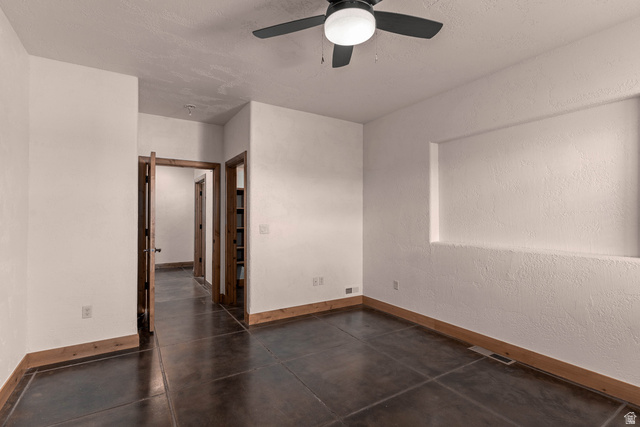 2464 East Granite Way St. George, UT 84790 - Photo 105 of 106 Unfurnished third bedroom with a ceiling fan and a textured wall