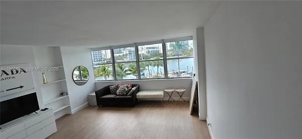 a living room with a bed furniture and a window