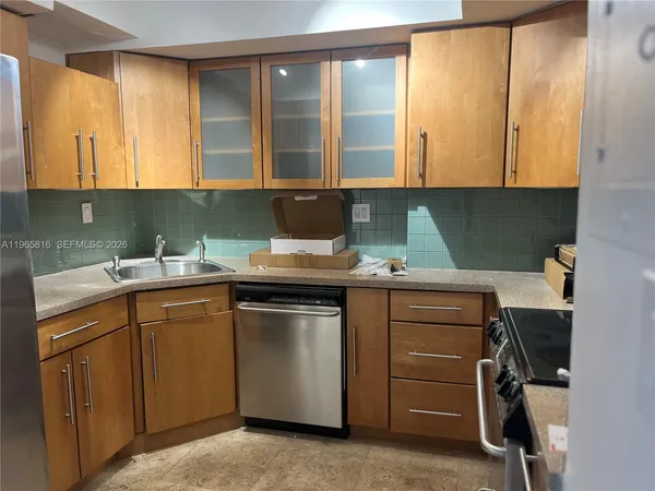 a kitchen with a sink window and cabinets