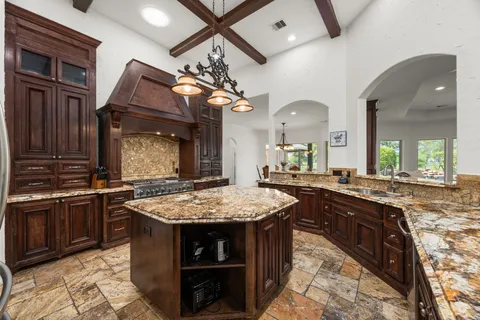a kitchen with stainless steel appliances granite countertop stove a sink dishwasher and cabinets with wooden floor