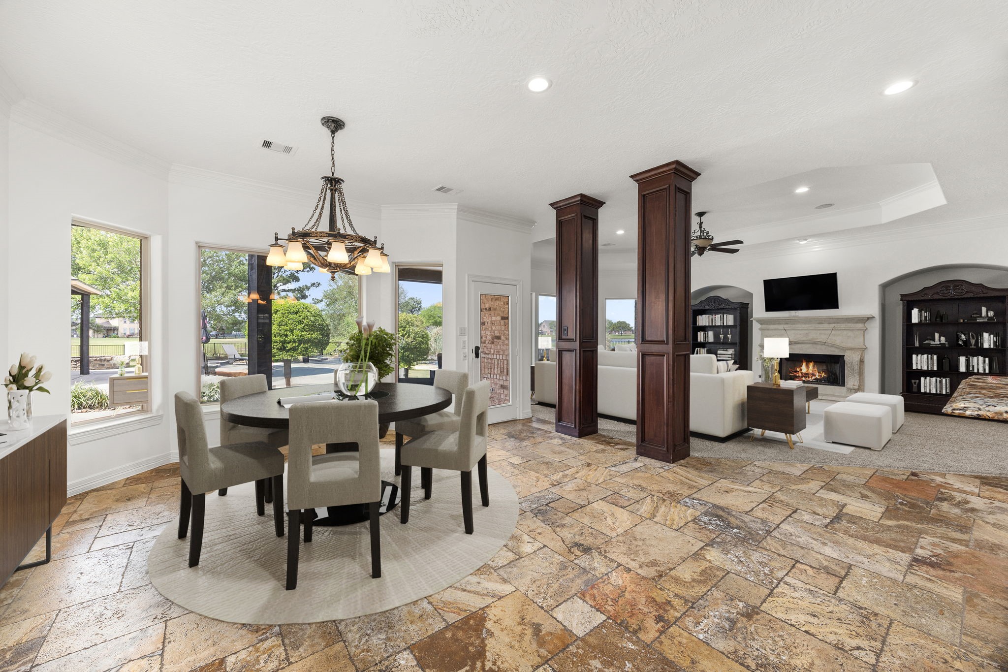 4611 Oasis Point Katy, TX 77493 - Photo 13 of 41 Enjoy views of your backyard oasis and lake beyond from the breakfast room, living room, and kitchen. The back wall of the home features expansive windows. The impressive scale of the entertaining spaces of the home allow you to entertain on a large scale if desired. Natural stone floors are complimented by the neutral paint color selected for the home's interior refresh for listing. Sherwin Williams Alabaster was chosen throughout the home to provide a light and bright base for the rich wood accents.