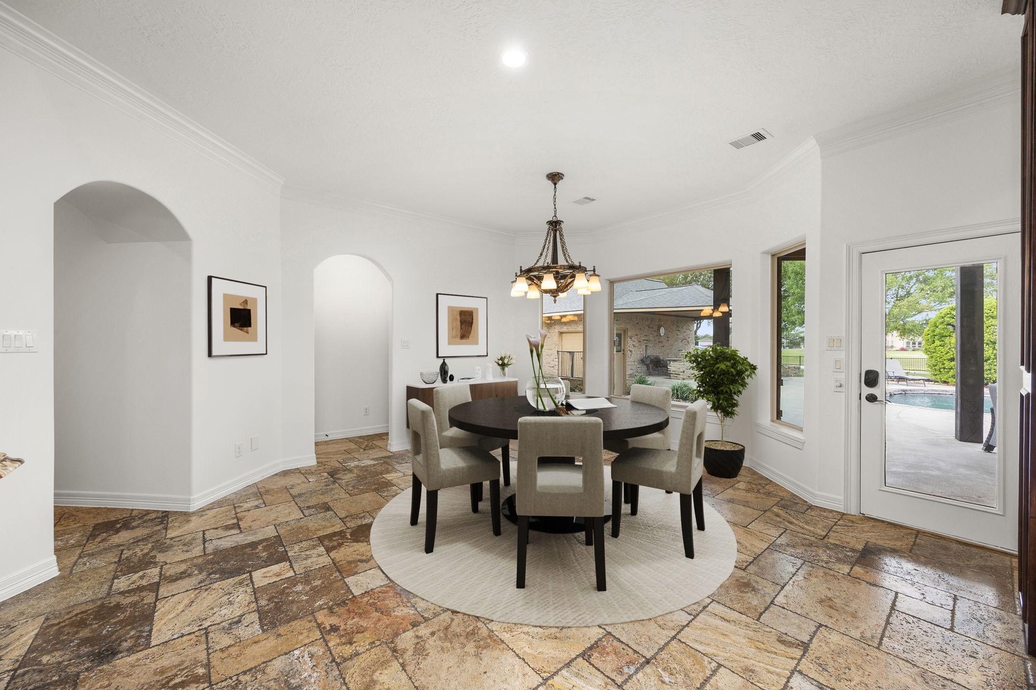 4611 Oasis Point Katy, TX 77493 - Photo 14 of 41 The archways seen from this perspective lead to the second living area on the left and to the large utility room on the right. Not seen is a large second pantry/closet in the hallway. Whether you need a "Costco closet," prefer a dedicated closet for outdoor linens, or have craft supplies galore, the walk-in storage space is impressive.