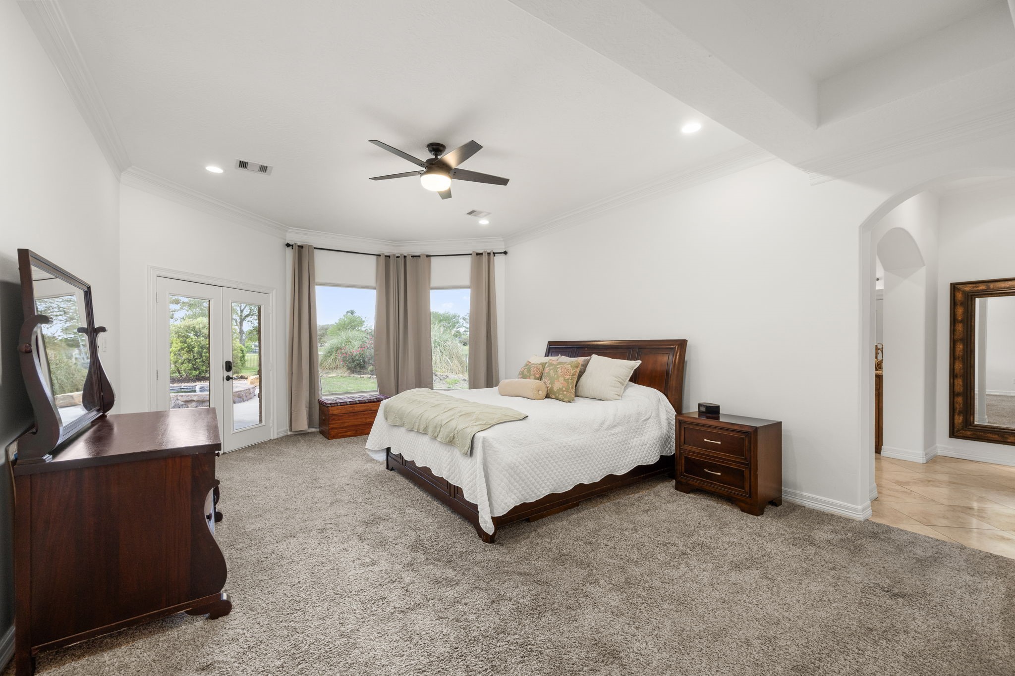 4611 Oasis Point Katy, TX 77493 - Photo 15 of 41 The King-sized primary suite is nestled at the rear of the home, away from the hustle and bustle of the provides privacy to this retreat space while allowing you to enjoy your lakeside views.