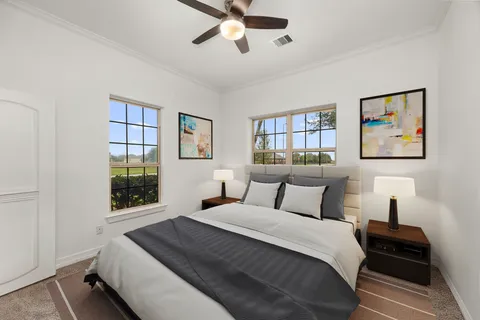 a bedroom with a large bed and a window