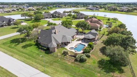 an aerial view of a house with a swimming pool yard and outdoor seating