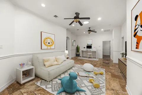 a living room with furniture and a chandelier